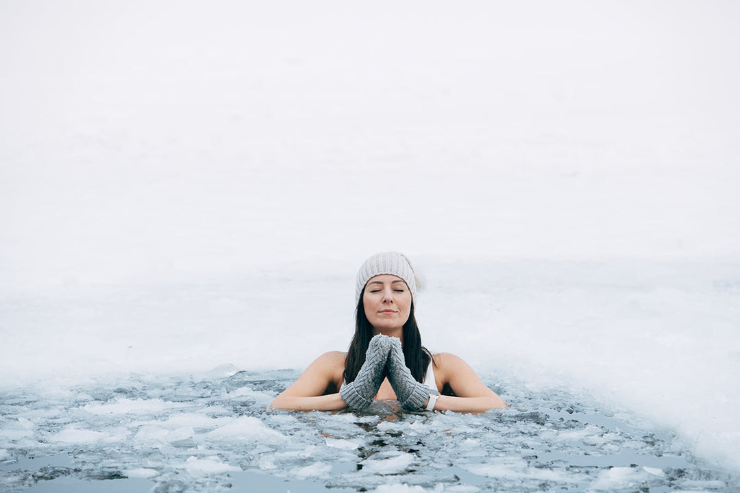 Woman sitting in an icy pond