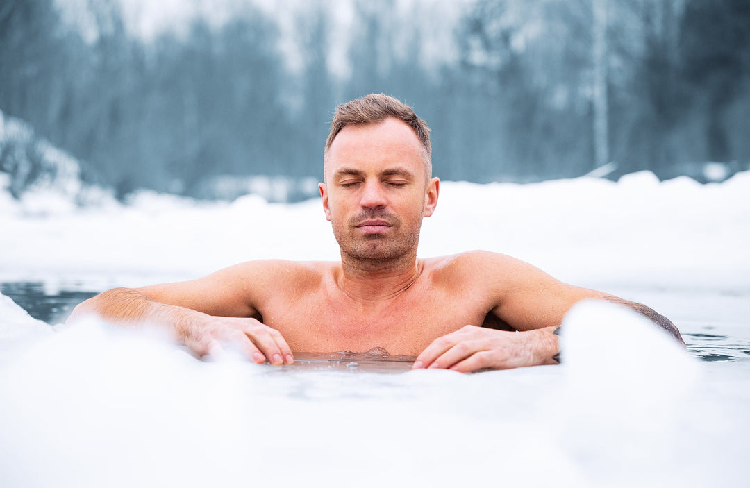 Man taking an ice bath in a pond
